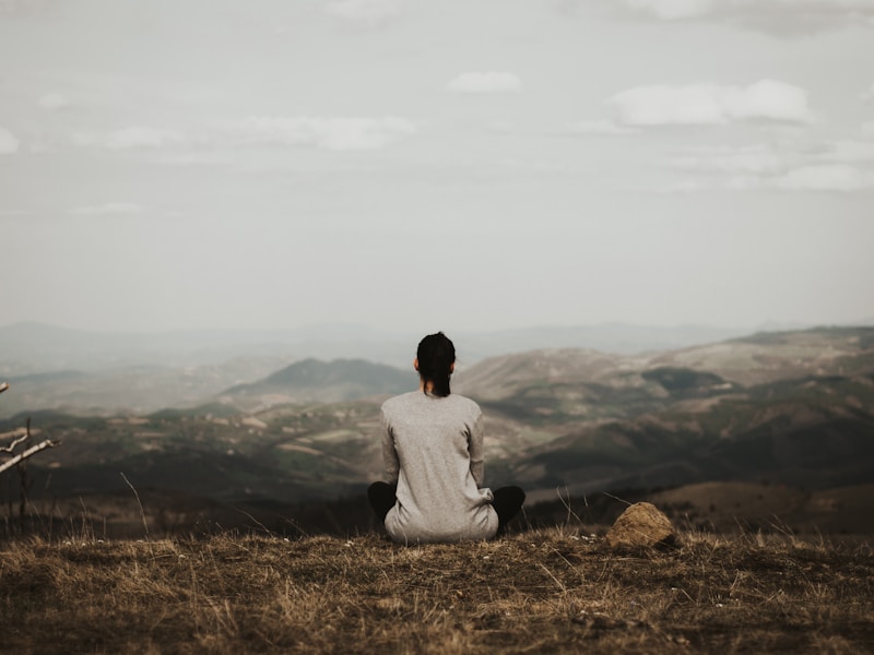 A person sitting quietly, grounded and present